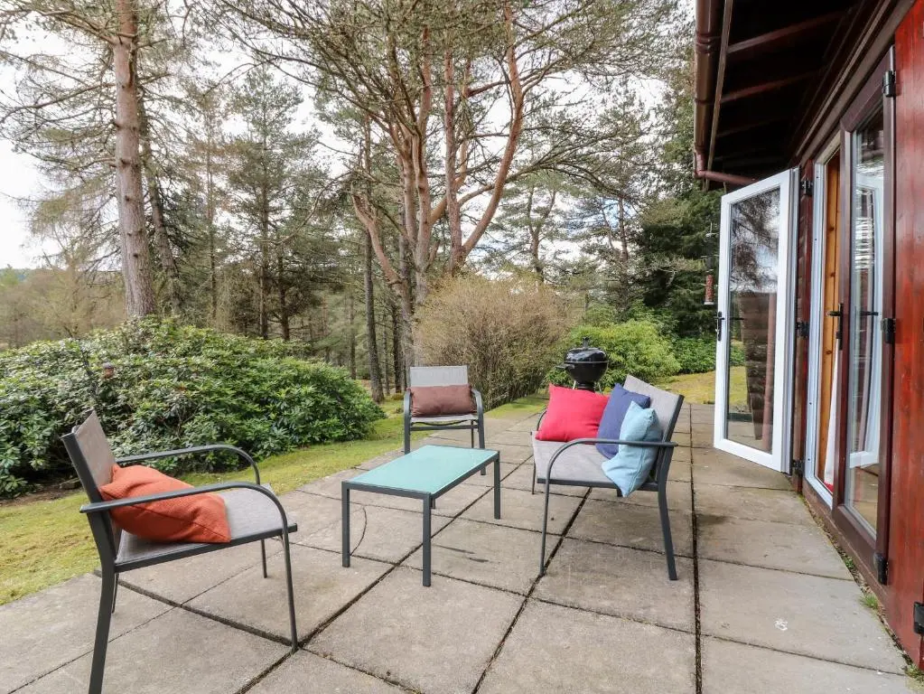 three chairs and a table on a patio at Rocksite in Blairgowrie
