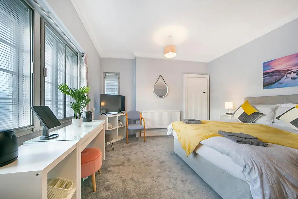 a bedroom with a bed and a desk with a computer at Constancevilla B7 - Grampian Lettings Ltd in Aberdeen