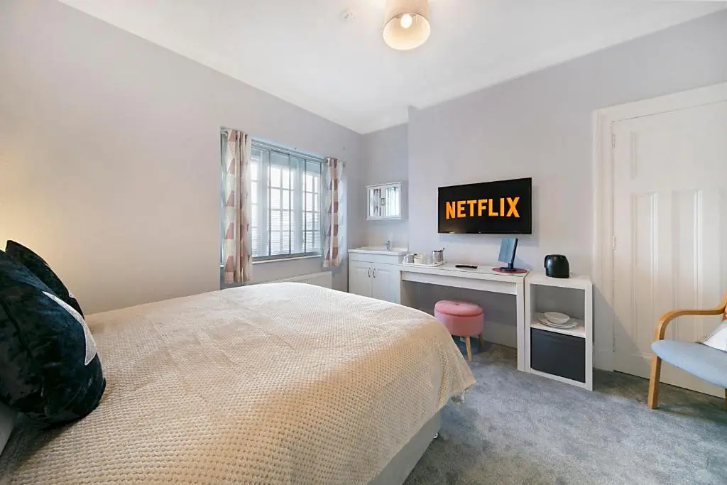a bedroom with a bed and a desk with a television at Constancevilla B7 - Grampian Lettings Ltd in Aberdeen