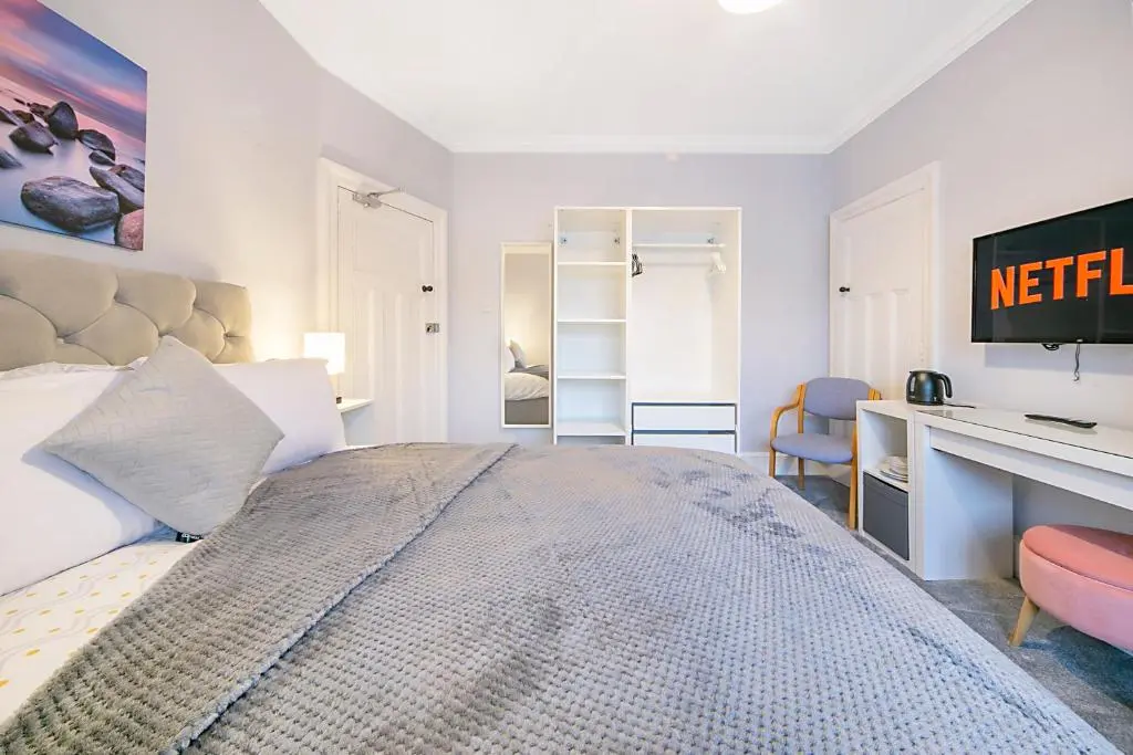 a bedroom with a large bed and a desk at Constancevilla B7 - Grampian Lettings Ltd in Aberdeen