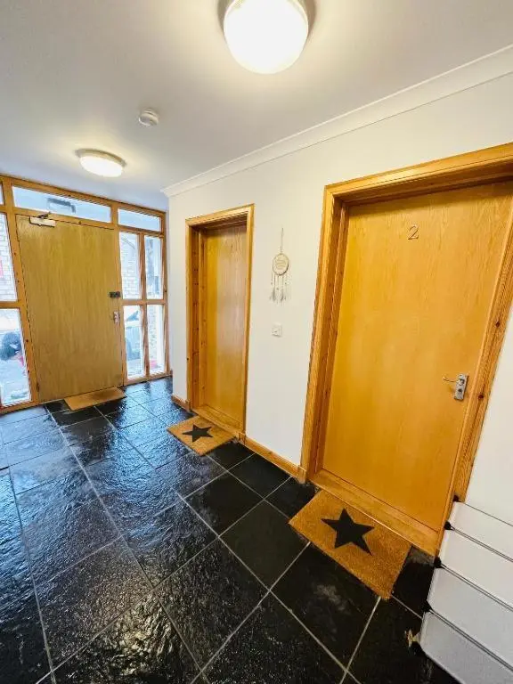 an empty room with doors and a tile floor at The Old Salt House, Flat1 in Wick