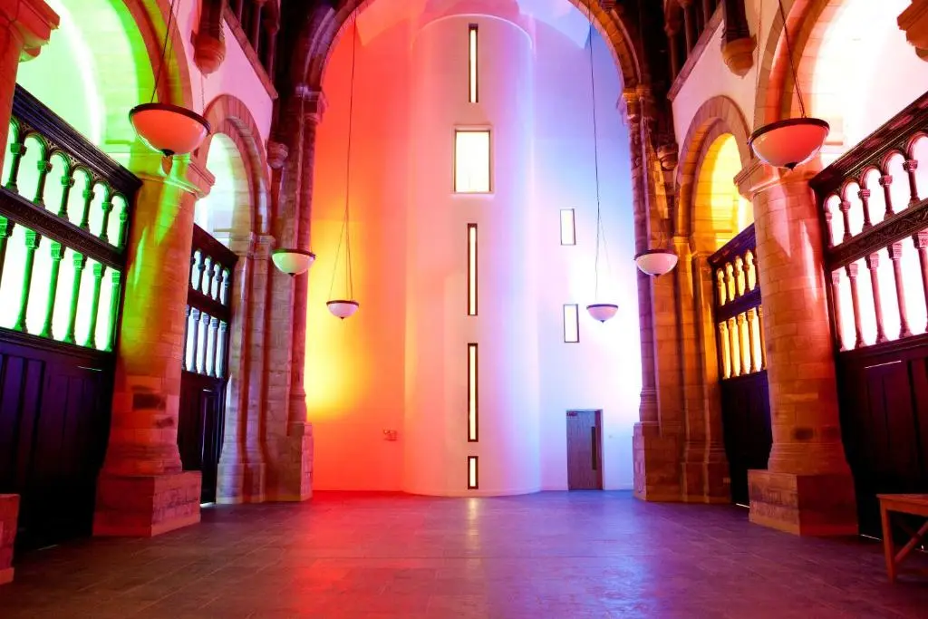 an empty hallway in a building with colorful lights at Abbey Garden at the Highland Club in Fort Augustus