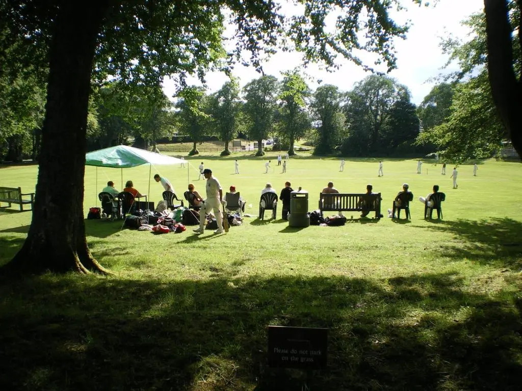 a group of people playing a game in a park at Abbey Garden at the Highland Club in Fort Augustus