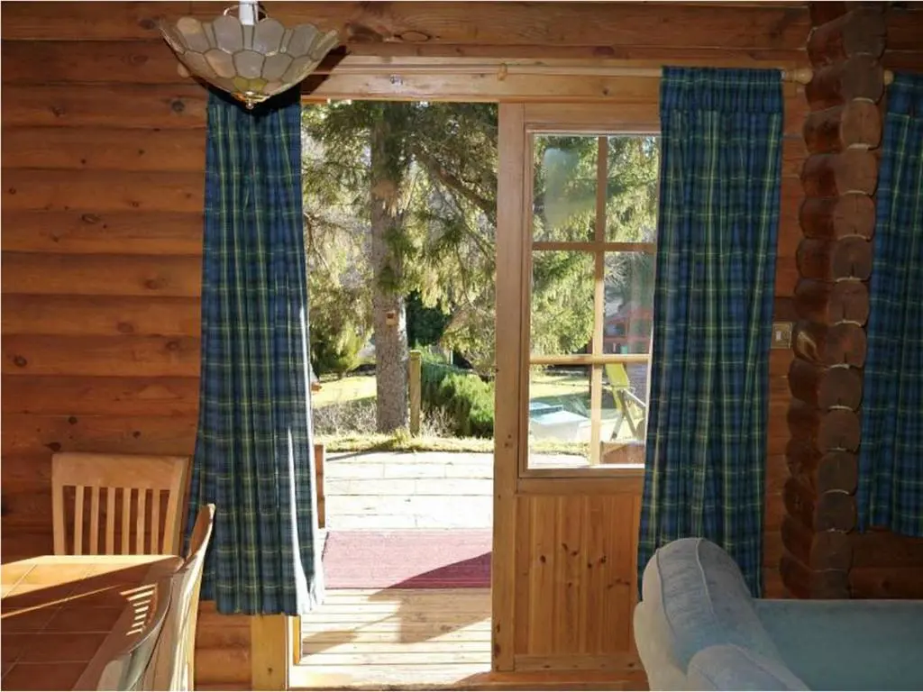 a room with a sliding glass door in a cabin at Bynack in Aviemore