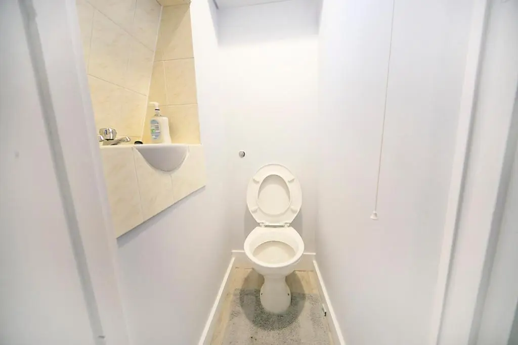 a white bathroom with a toilet and a sink at Constancevilla B8 - Grampian Lettings Ltd in Aberdeen