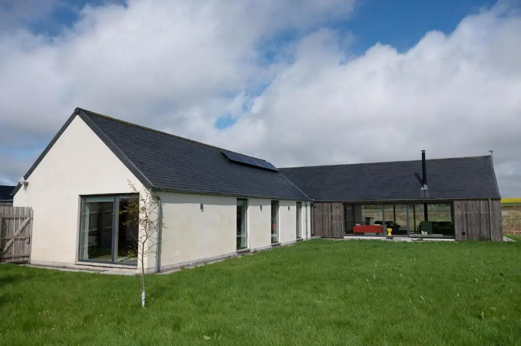 a white house with a black roof at Stunning Rural Retreat Sleeps\u00a024 in Aberdeen