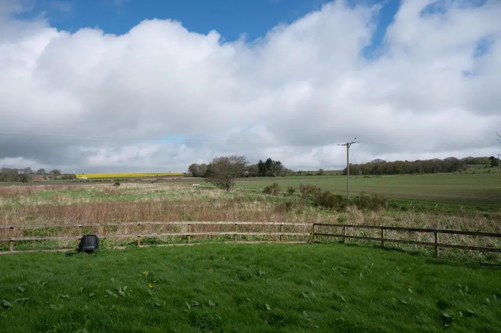 a fence in the middle of a field at Stunning Rural Retreat Sleeps\u00a024 in Aberdeen