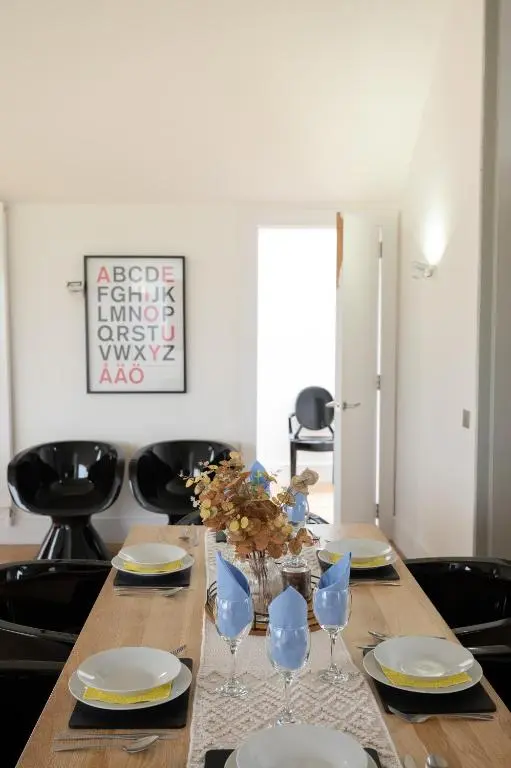 a wooden table with plates and wine glasses on it at Stunning Rural Retreat Sleeps\u00a024 in Aberdeen