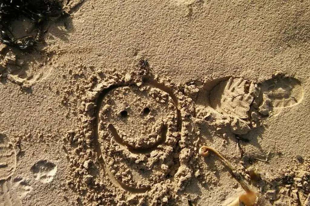 a smiley face drawn in the sand on the beach at Applegrove, perfect 2 bed bungalow, Fortrose in Fortrose