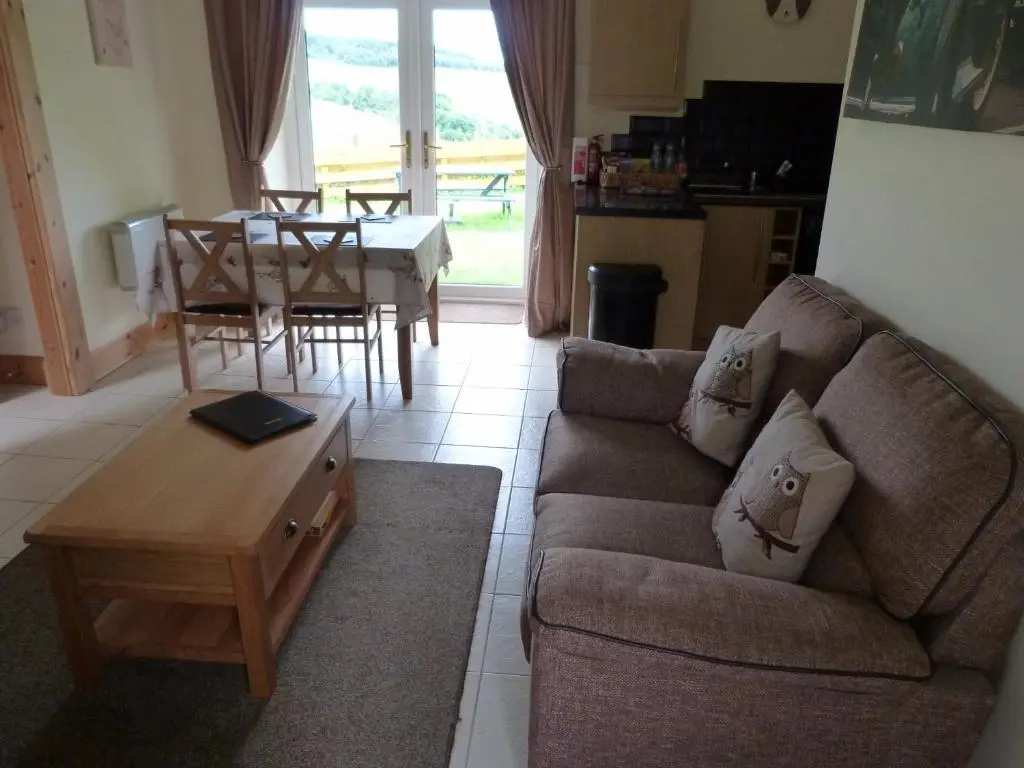 a living room with a couch and a table at Broomhead Cottages in Dufftown