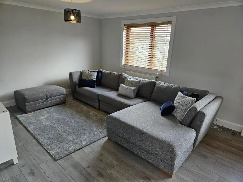 a living room with a couch and a chair at NO 40 - 3 bed all with smart tv FULLY FITTED KITCHEN, Spacious living accommodation, FREE PARKING - ideal for TRADES, reduction for LONG STAYS part of Langley Cottages and Apartments in Wick