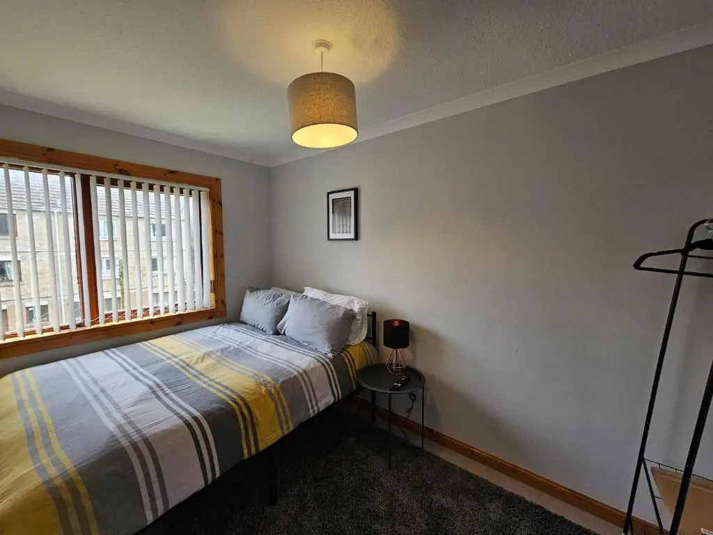 a bedroom with a bed and a window at NO 40 - 3 bed all with smart tv FULLY FITTED KITCHEN, Spacious living accommodation, FREE PARKING - ideal for TRADES, reduction for LONG STAYS part of Langley Cottages and Apartments in Wick