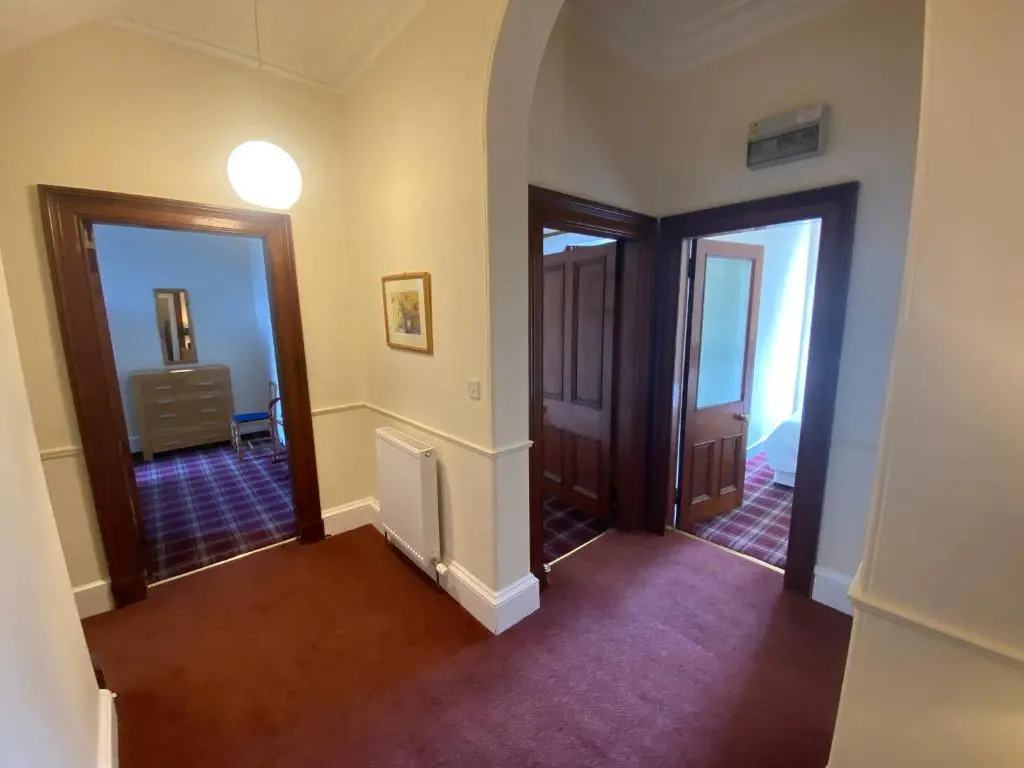 an empty hallway with two doors and a room at 92 High Street in Aberlour