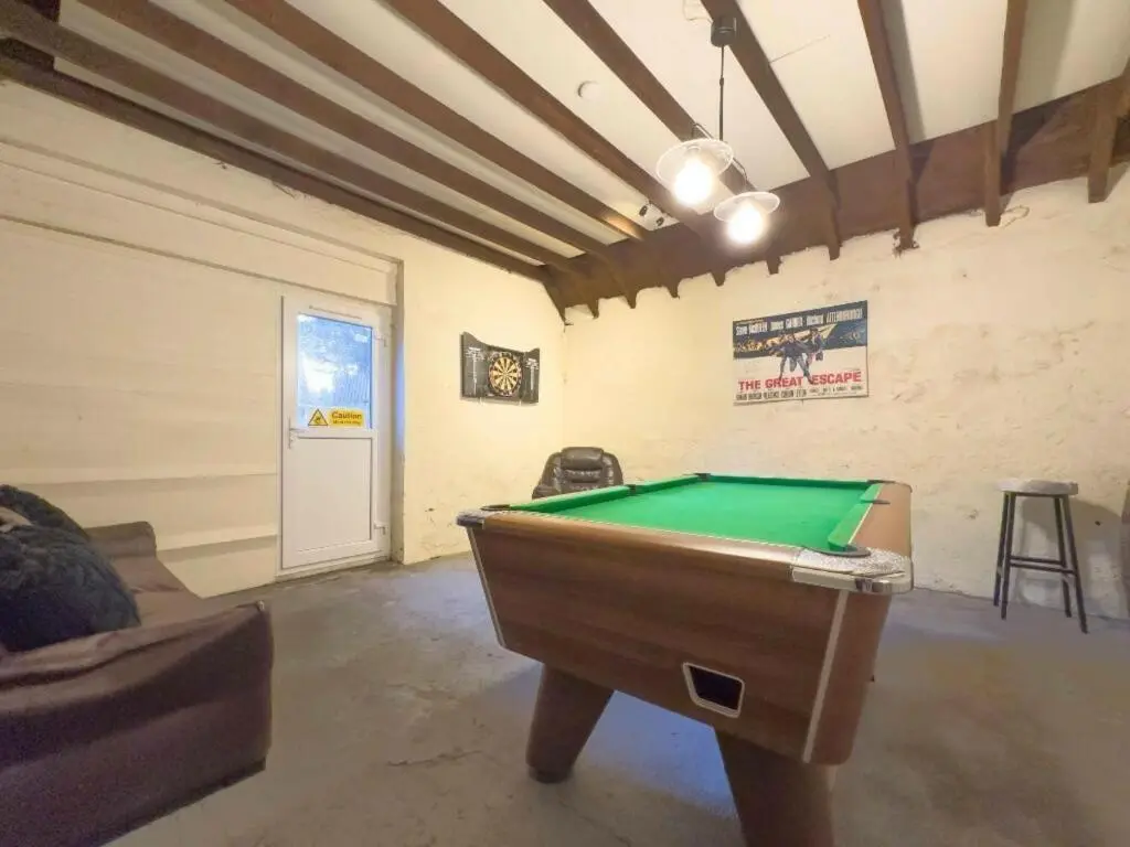 a living room with a pool table in it at OYO Eastbank Hotel, Speyside Scotland in Rothes
