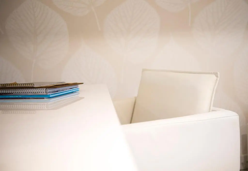 a stack of books sitting on top of a white refrigerator at Heathmount Hotel in Inverness