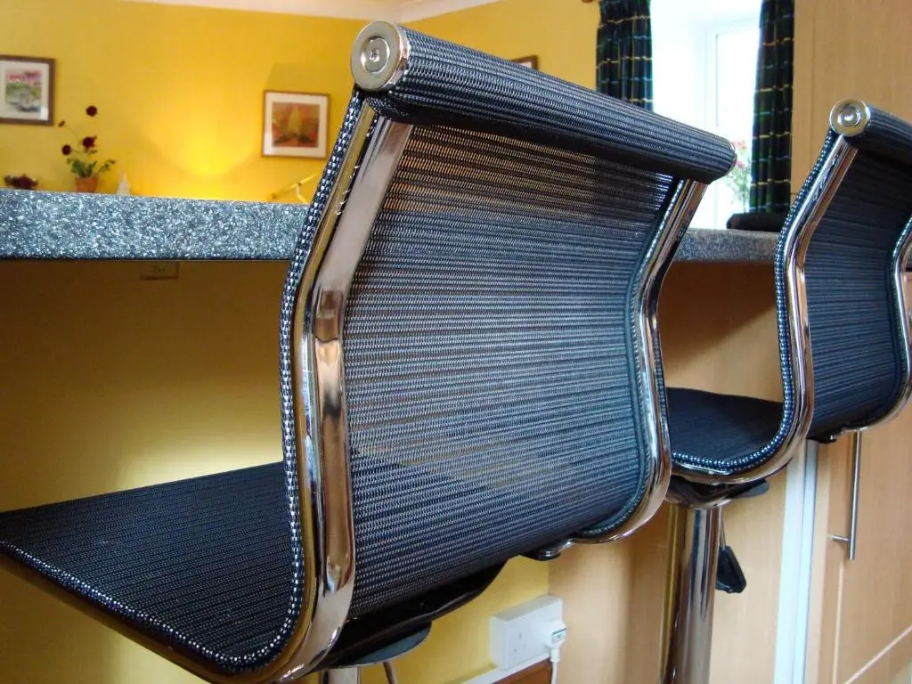 a pair of black chairs in a kitchen at The Bothy At Willowbank in Grantown on Spey