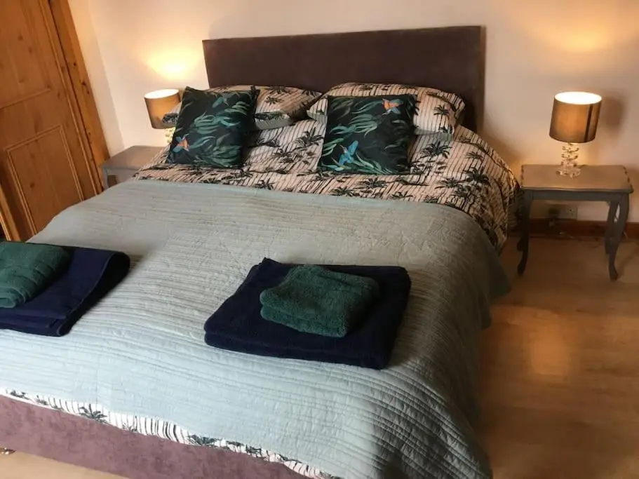 a bedroom with a bed with two pillows on it at Bonnie Bide Huntly Aberdeenshire in Huntly
