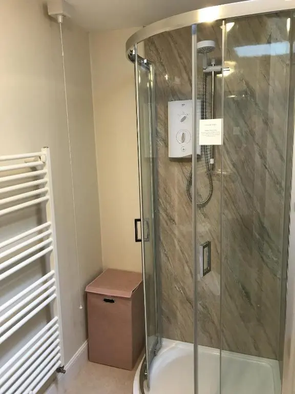 a shower with a glass enclosure in a bathroom at The Struan Inn Self Catering Lodge in Struan