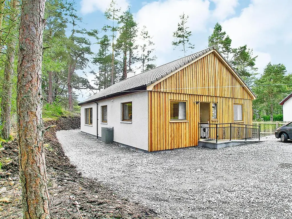 a smallshed with a white and wooden building at Clunymhore in Nethy Bridge