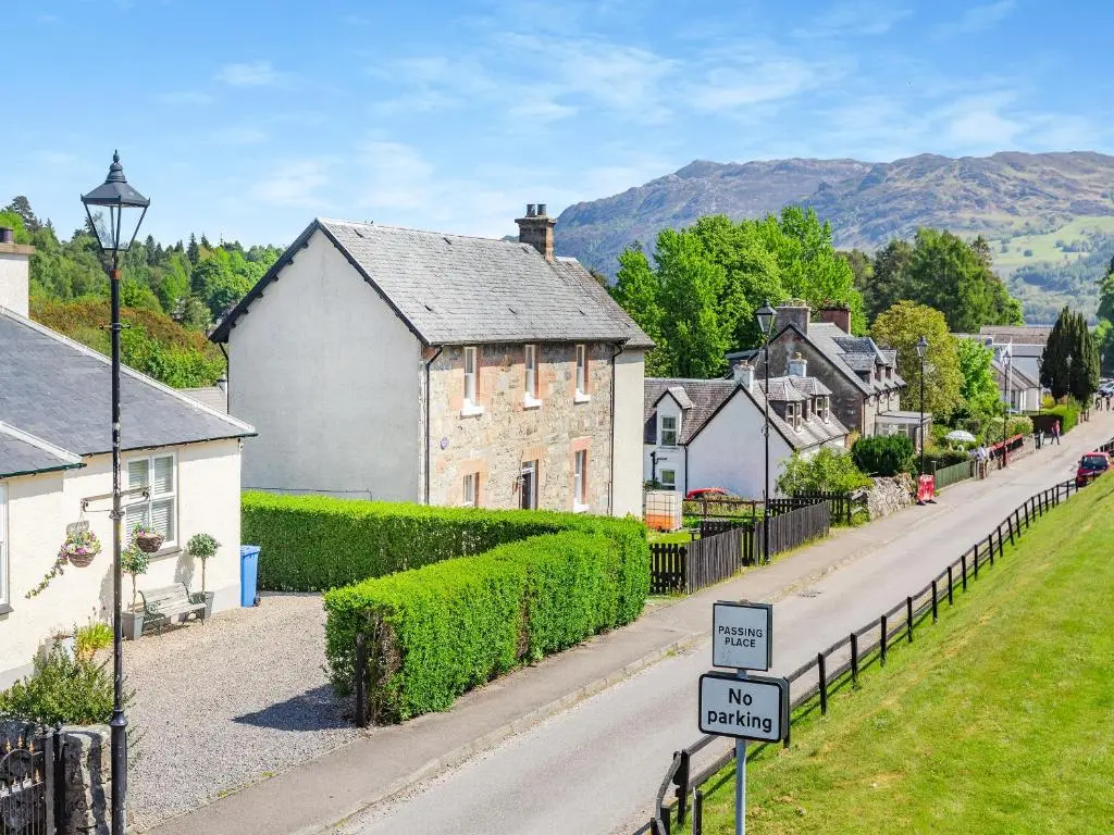 a street in a village with houses and a street sign at Lockview Upper Flat in Fort Augustus