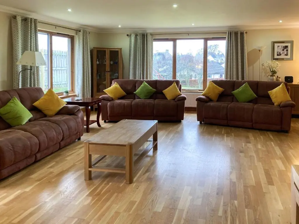 a living room with two couches and a coffee table at Sandy Beach in Nairn