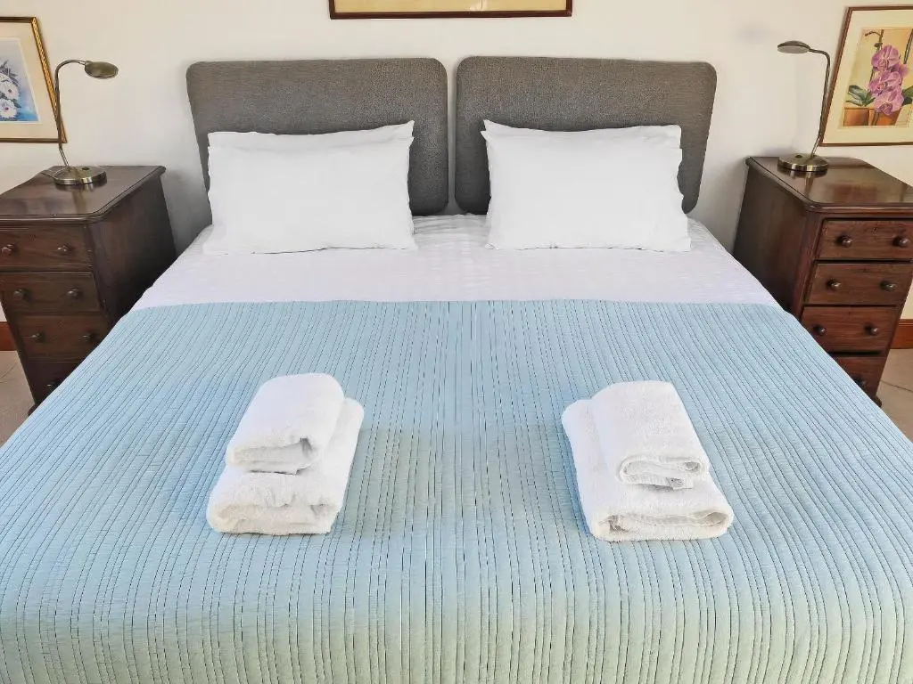 a bedroom with a bed with towels on it at The Townhouse in Inverness