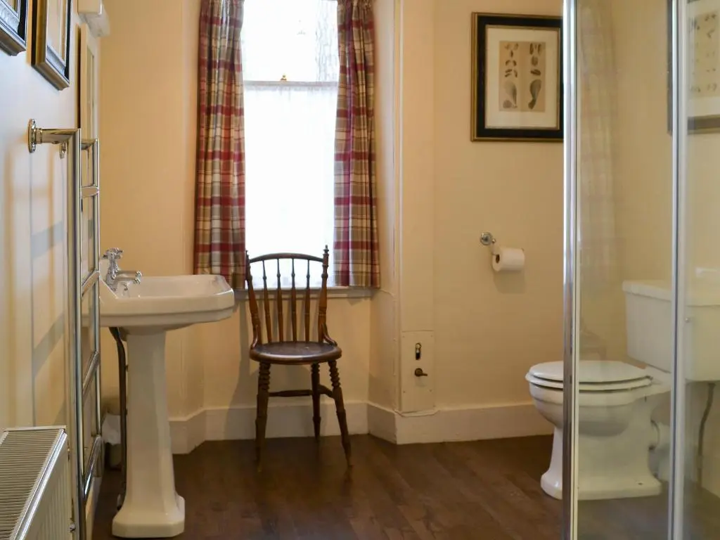 a bathroom with a sink and a toilet and a window at Einich in Newtonmore