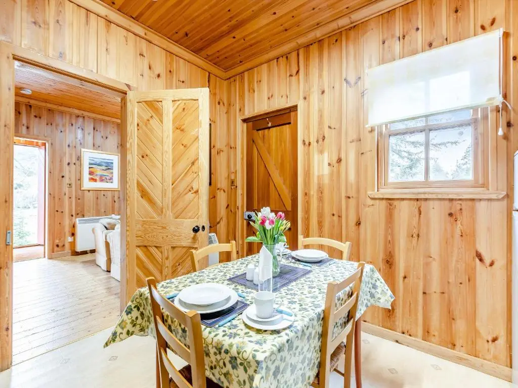 a dining room with a table and chairs at Stuffer's Cottage in Inverey