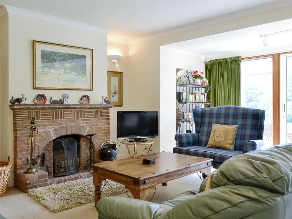 a living room with a couch and a fireplace at Laird's Cast in Banchory
