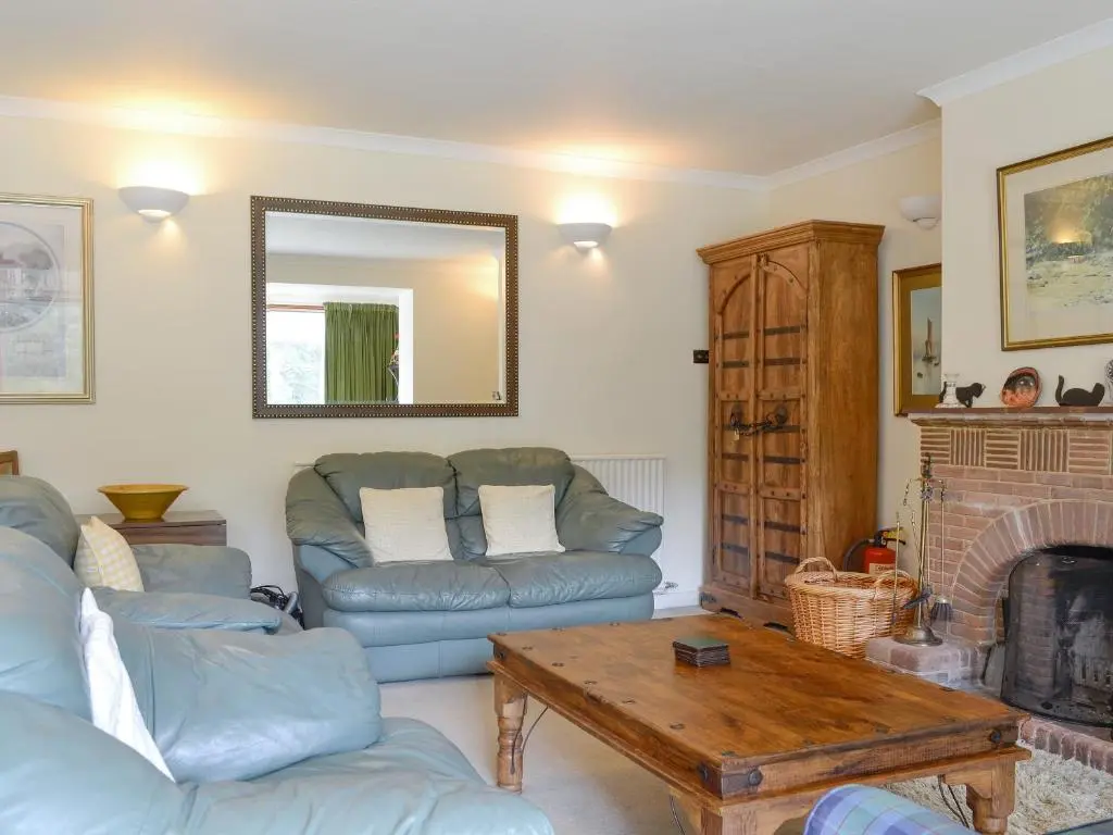 a living room with a couch and a table at Laird's Cast in Banchory