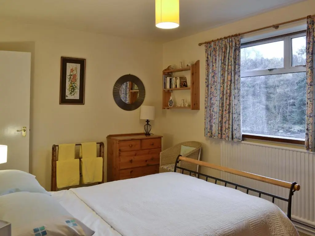 a bedroom with a bed and a window at Laird's Cast in Banchory