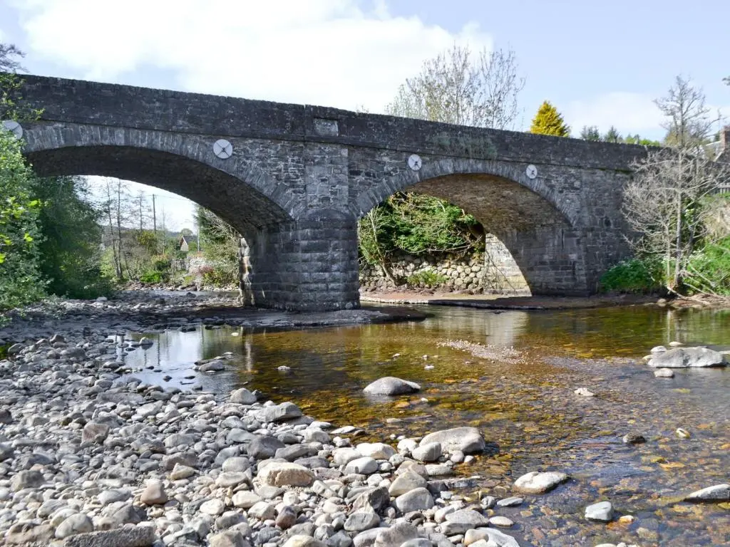 an old stone bridge over a river at Sunnyside in Kirkmichael