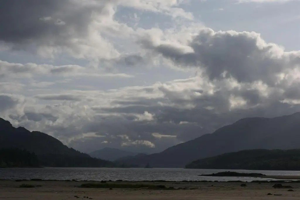 a large body of water with mountains in the background at Spectacular Mountain View Ecopod in Newtonmore