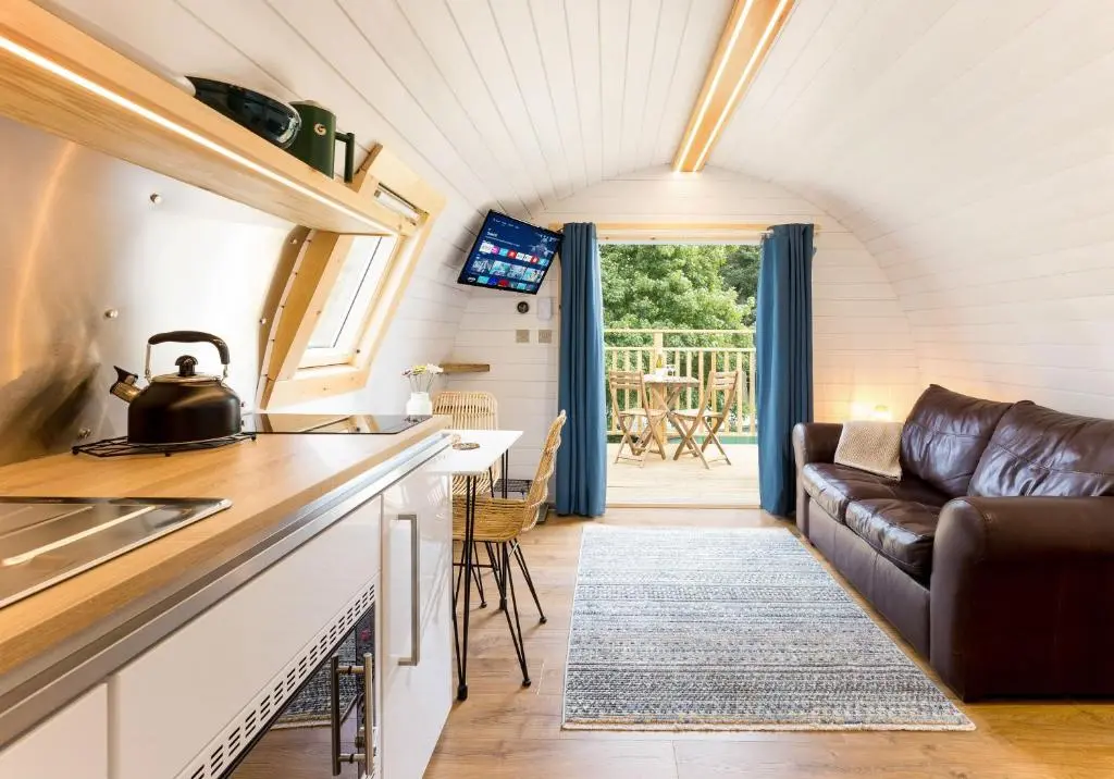 a kitchen and living room in a tiny house at Spectacular Mountain View Ecopod in Newtonmore