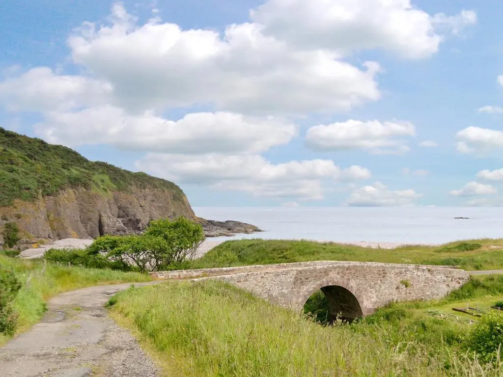an old bridge over a dirt road near the beach at Pennan Lodge - 26818 in Pennan