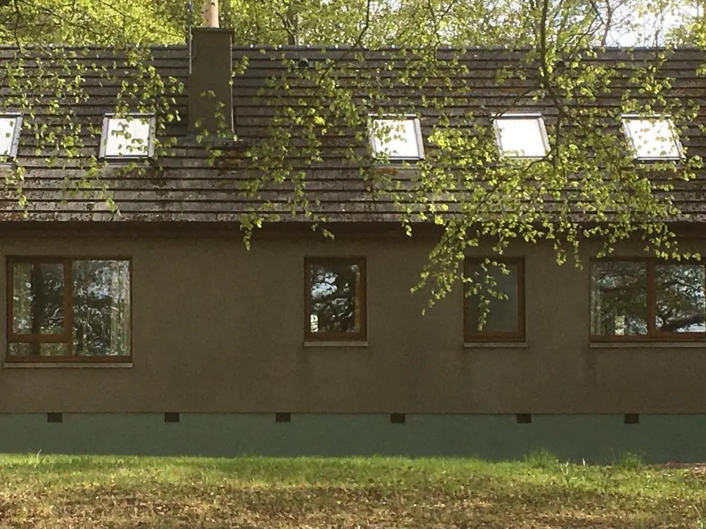 a building with a roof covered in ivy at Scobach Lodge in Turriff