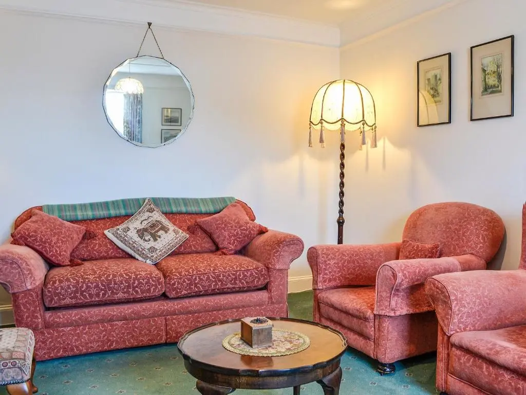 a living room with a couch and two chairs and a table at St Enodoc in Ullapool