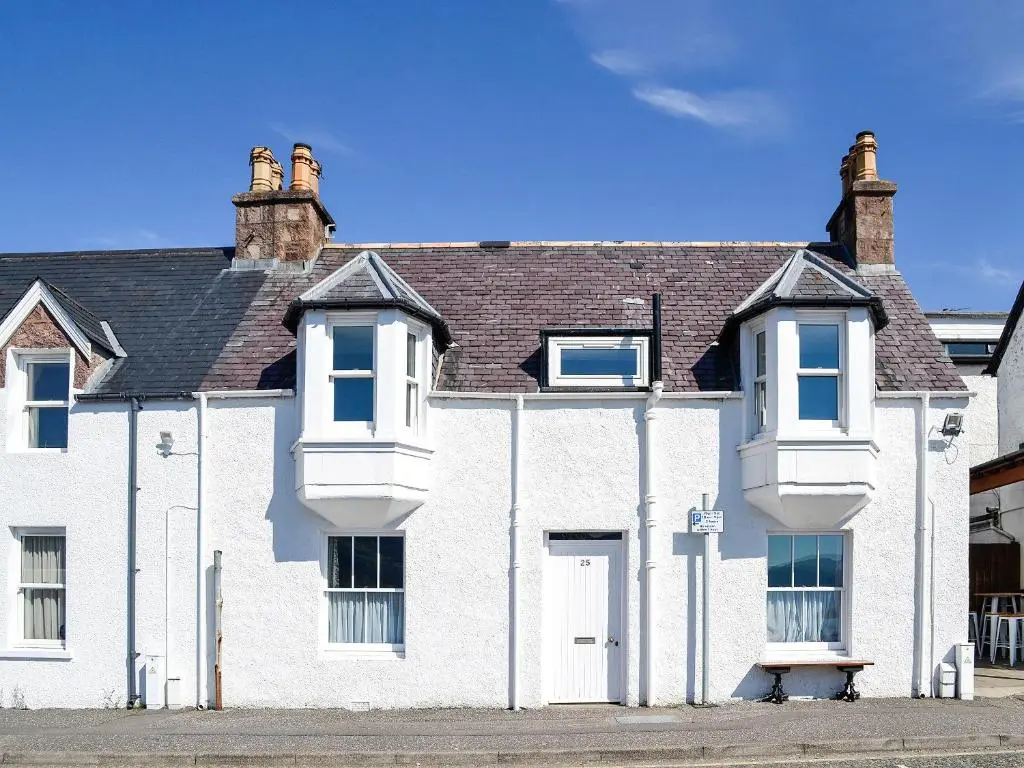 a large white house with a roof at St Enodoc in Ullapool