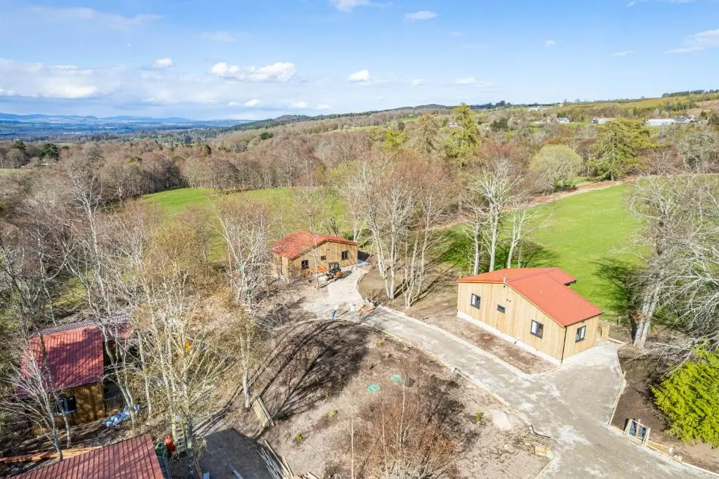 an aerial view of a house and a farm at Breckland Lodge 4 with Hot Tub in Belladrum