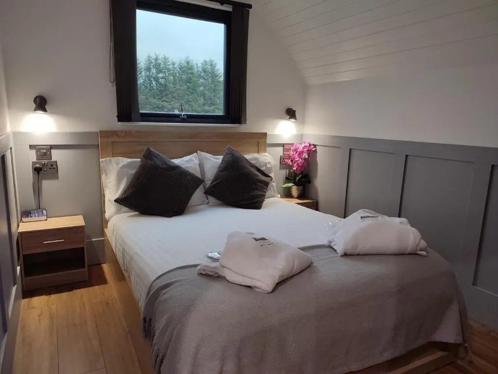 a bedroom with a bed with two pillows on it at Ben Aigan in Keith