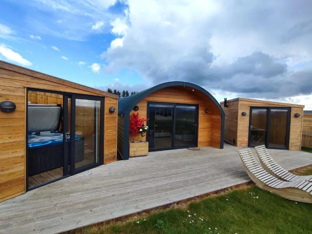 a house with a large deck with a tv on it at Ben Aigan in Keith