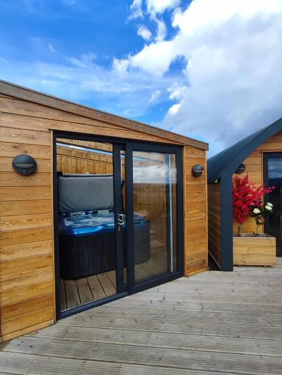 a wooden house with a large window on a deck at Ben Aigan in Keith
