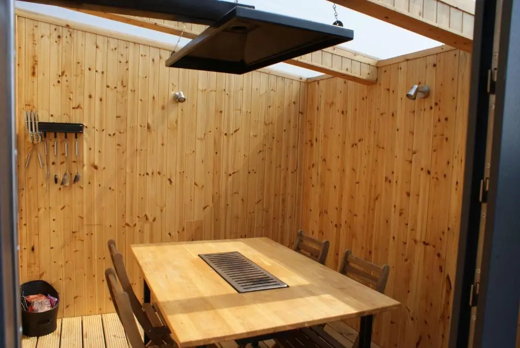 a wooden table and chairs in a room with wood paneling at Meikle Balloch in Keith