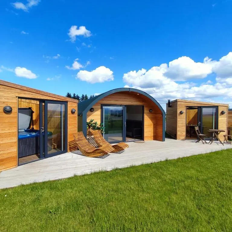 a house with a large deck with chairs on it at Ben Rinnes in Keith