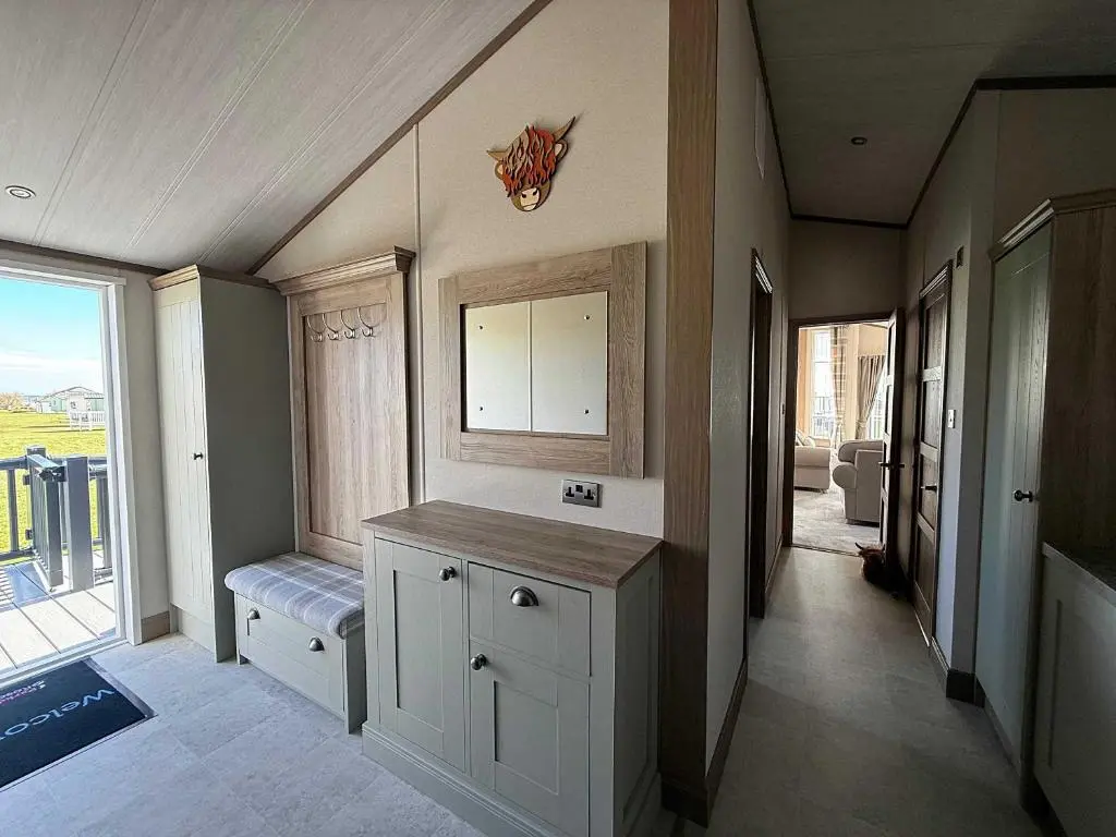 a kitchen with a counter and a window with a view at Highland Holiday Getaways - The Heilan' Lodge in Embo