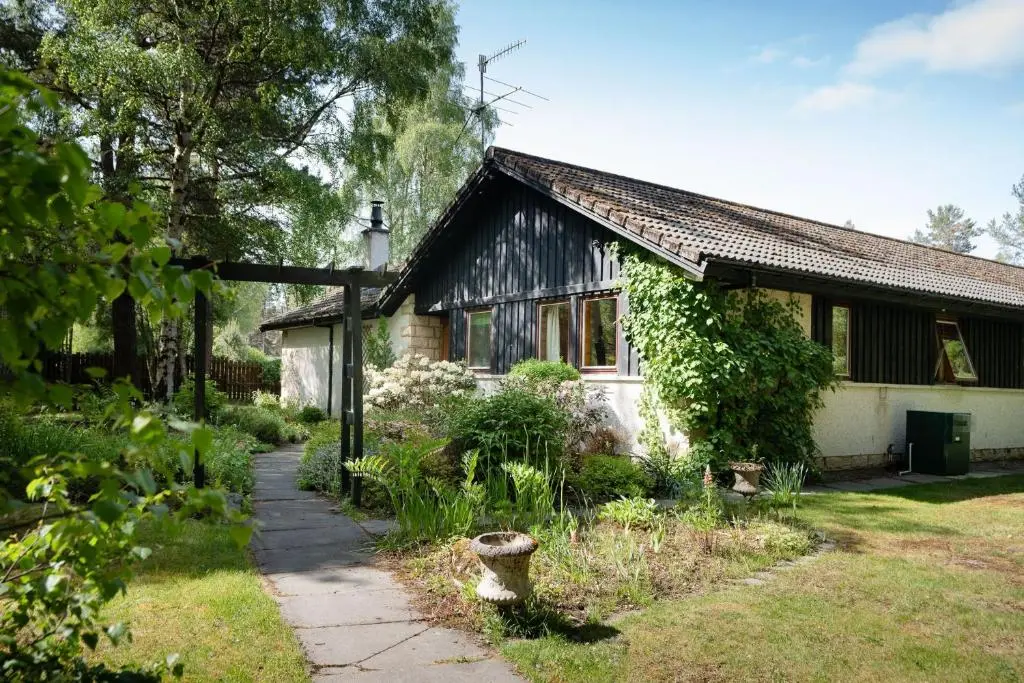 a small house with a garden in front of it at Langrick in Nethy Bridge