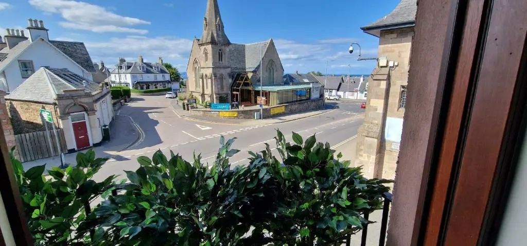 a view from a window of a town with a church at Colin Young Place in Nairn