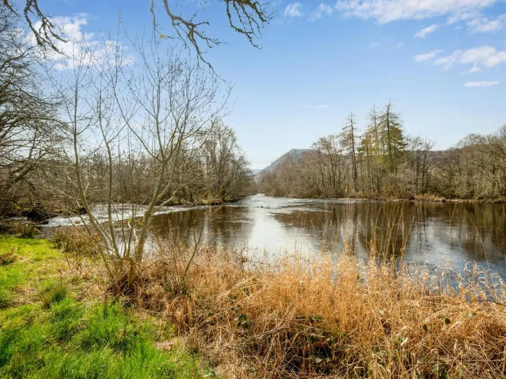 a view of a river with mountains in the background at Holiday Home Lochness by Interhome in Contin