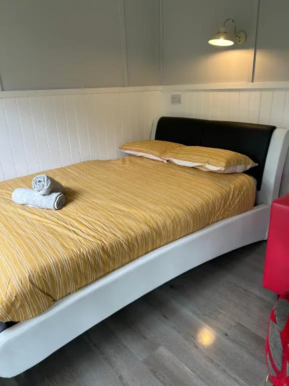 a bed with a stuffed animal sitting on top of it at 1Lochness glam lodges in Inverness