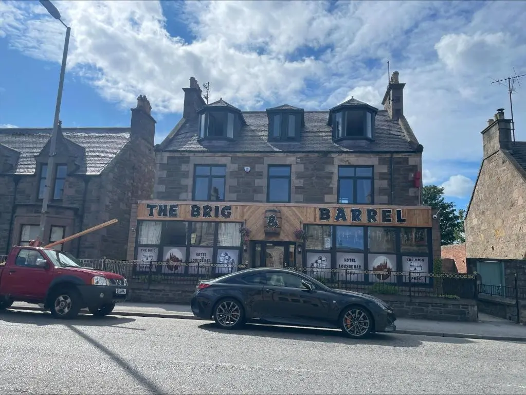 a car parked in front of a barlished building at The Brig & Barrel hotel in Buckie